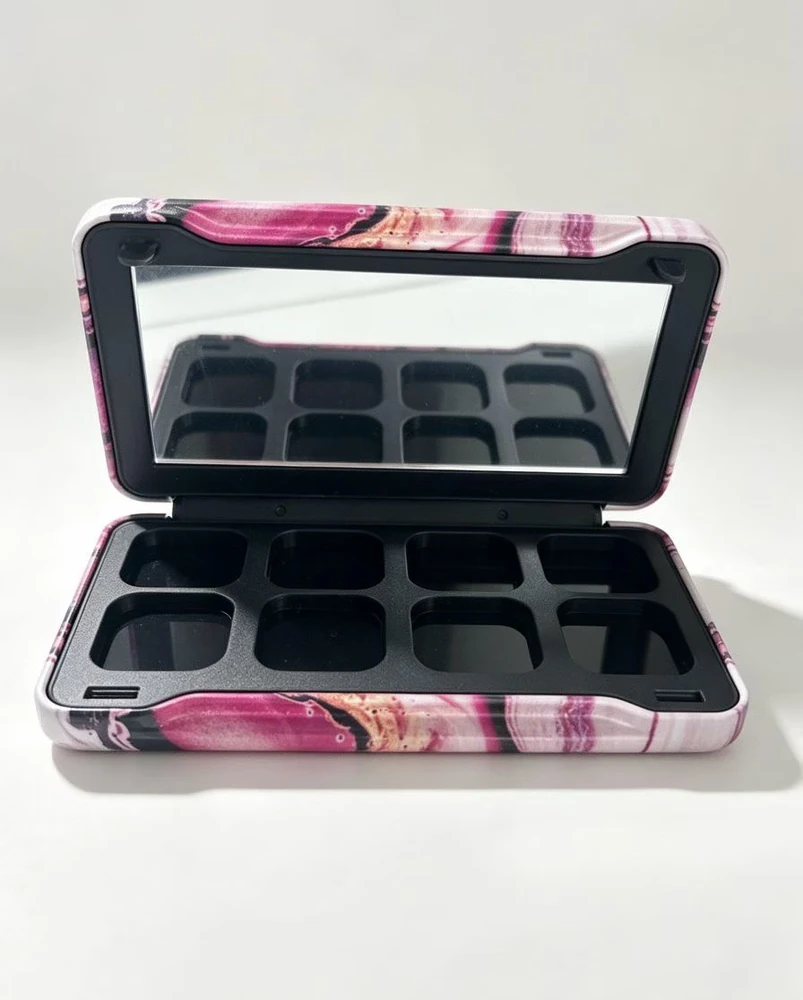 Open cosmetic palette case with a mirror and fitted insert